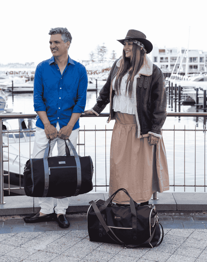 Two travellers on the marina with their GLASARI duffles