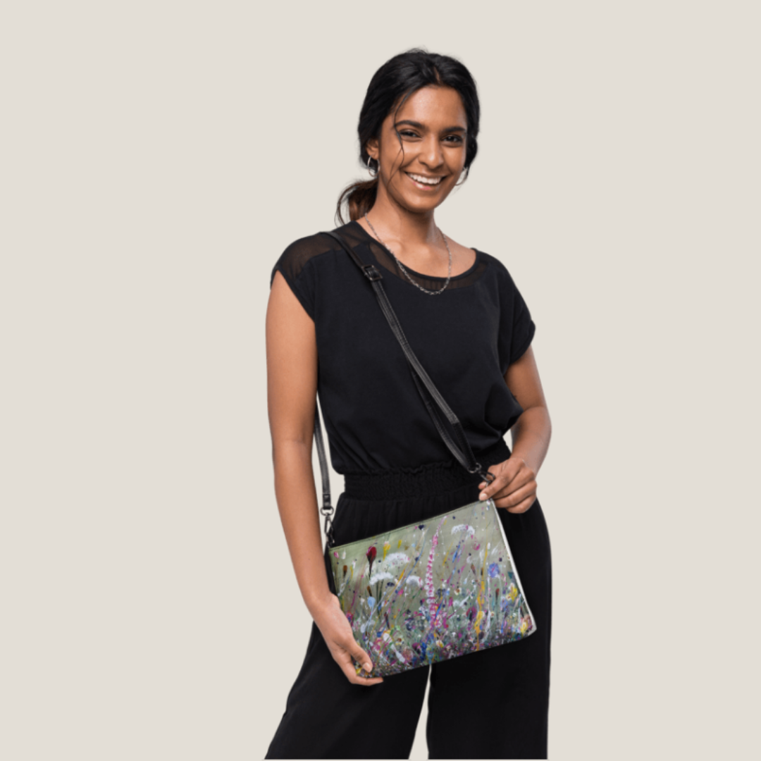 GLASARI Art Cross-Body Bag in Wind Swept Floral worn across the body by a smiling woman in a black outfit