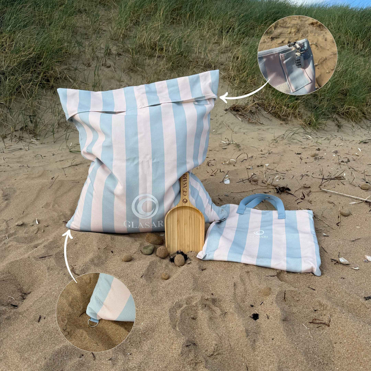 GLASARI Beach Buddy Vault in Blue Horizon stripe filled with sand, with close-ups of the combination lock and the D-ring for attaching a dog lead or sunshade, plus the matching carry bag and free bamboo scoop