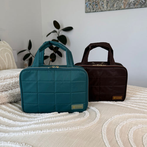 GLASARI On-The-Glow Cosmetic Case in Ocean Emerald and Cocoa Drift on a cream bed