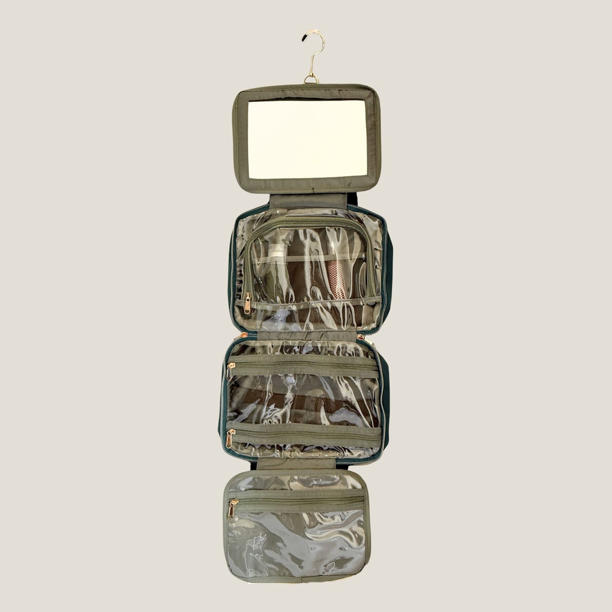 GLASARI On-The-Glow Cosmetic Case in Ocean Emerald hanging fully unfolded, showing the built-in mirror, clear zip pockets and hanging hook