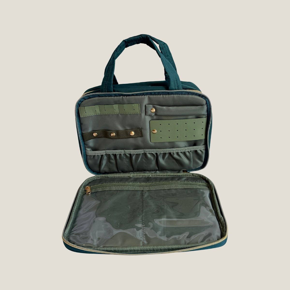 GLASARI On-The-Glow Cosmetic Case in Ocean Emerald lying open, showing the jewellery section and clear zip pocket