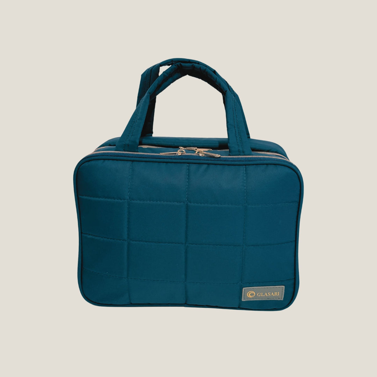 GLASARI On-The-Glow Cosmetic Case in Ocean Emerald, quilted with two top handles and the GLASARI label