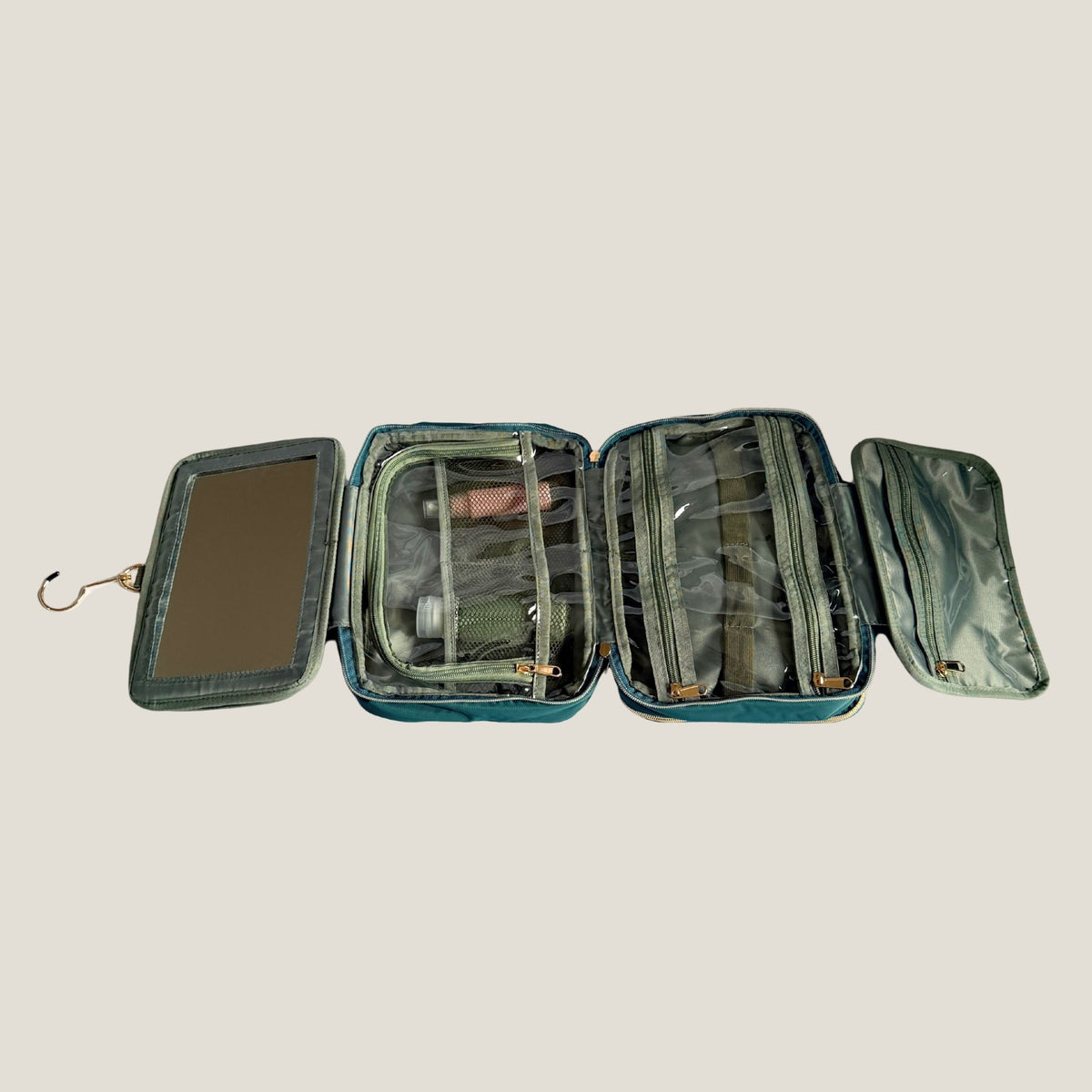 GLASARI On-The-Glow Cosmetic Case in Ocean Emerald unfolded flat, showing the mirror, four zip compartments and hanging hook