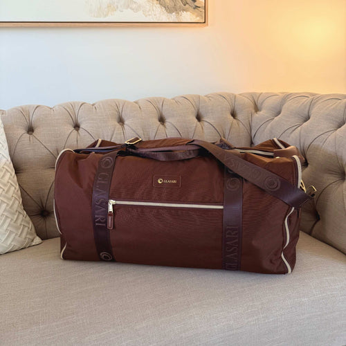 GLASARI Retreat Duffle in Cocoa Drift, styled on a lounge in a living room setting