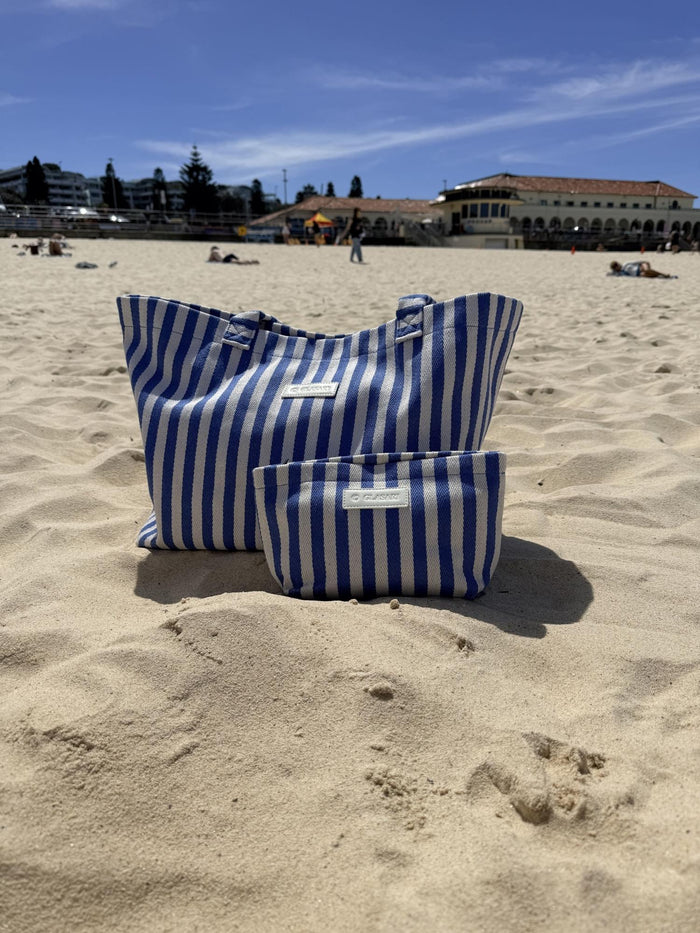 The Shore Tote in blue stripe on the sand at Bondi Beach