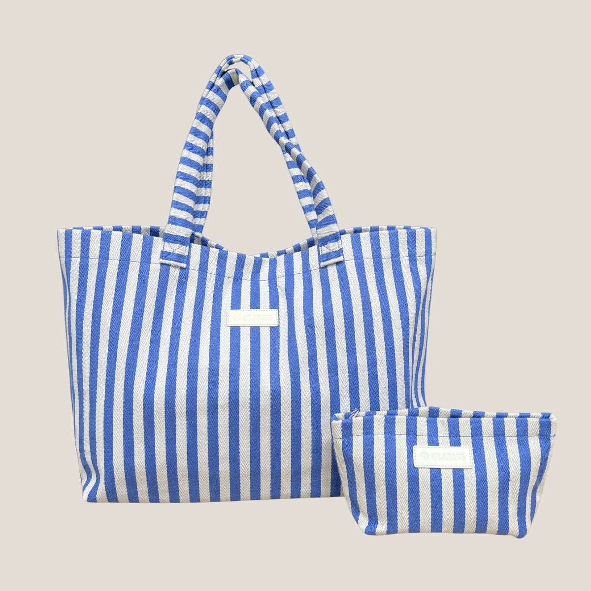 GLASARI Shore Tote in Ocean Blue Stripe, a blue and cream striped herringbone cotton beach tote with its matching zip pouch