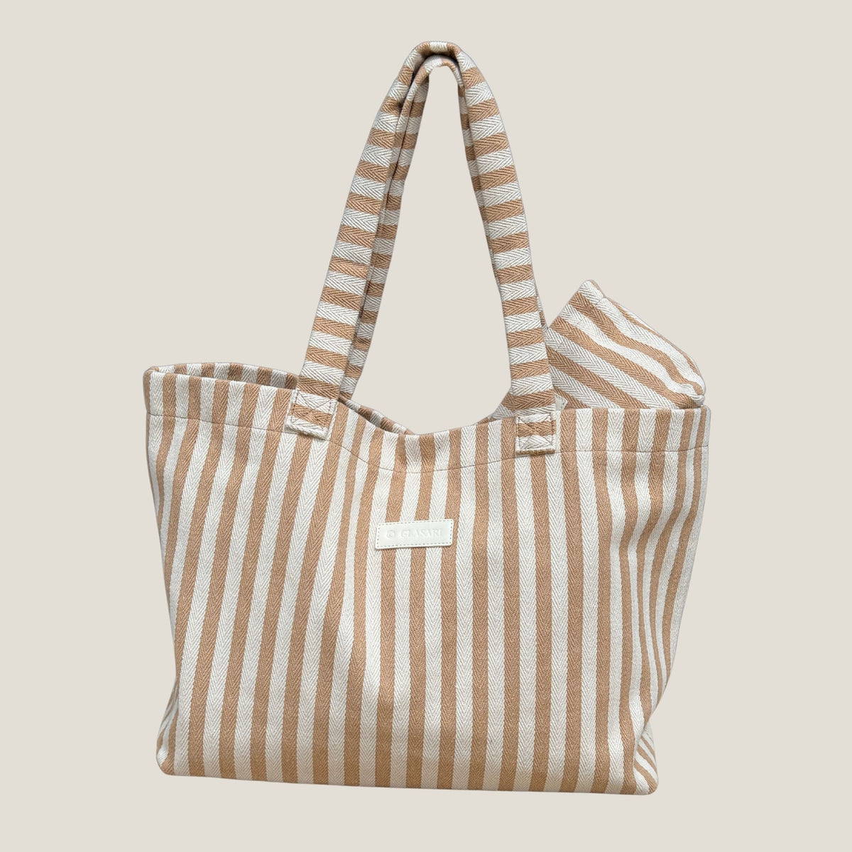 GLASARI Shore Tote in Sand Dune Stripe with its matching pouch tucked inside, showing the tan and cream herringbone cotton weave