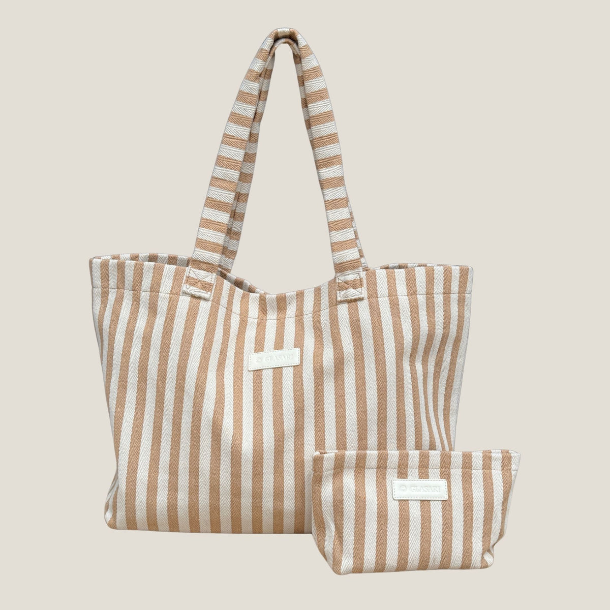 GLASARI Shore Tote in Sand Dune Stripe, a tan and cream striped herringbone cotton beach tote with its matching zip pouch